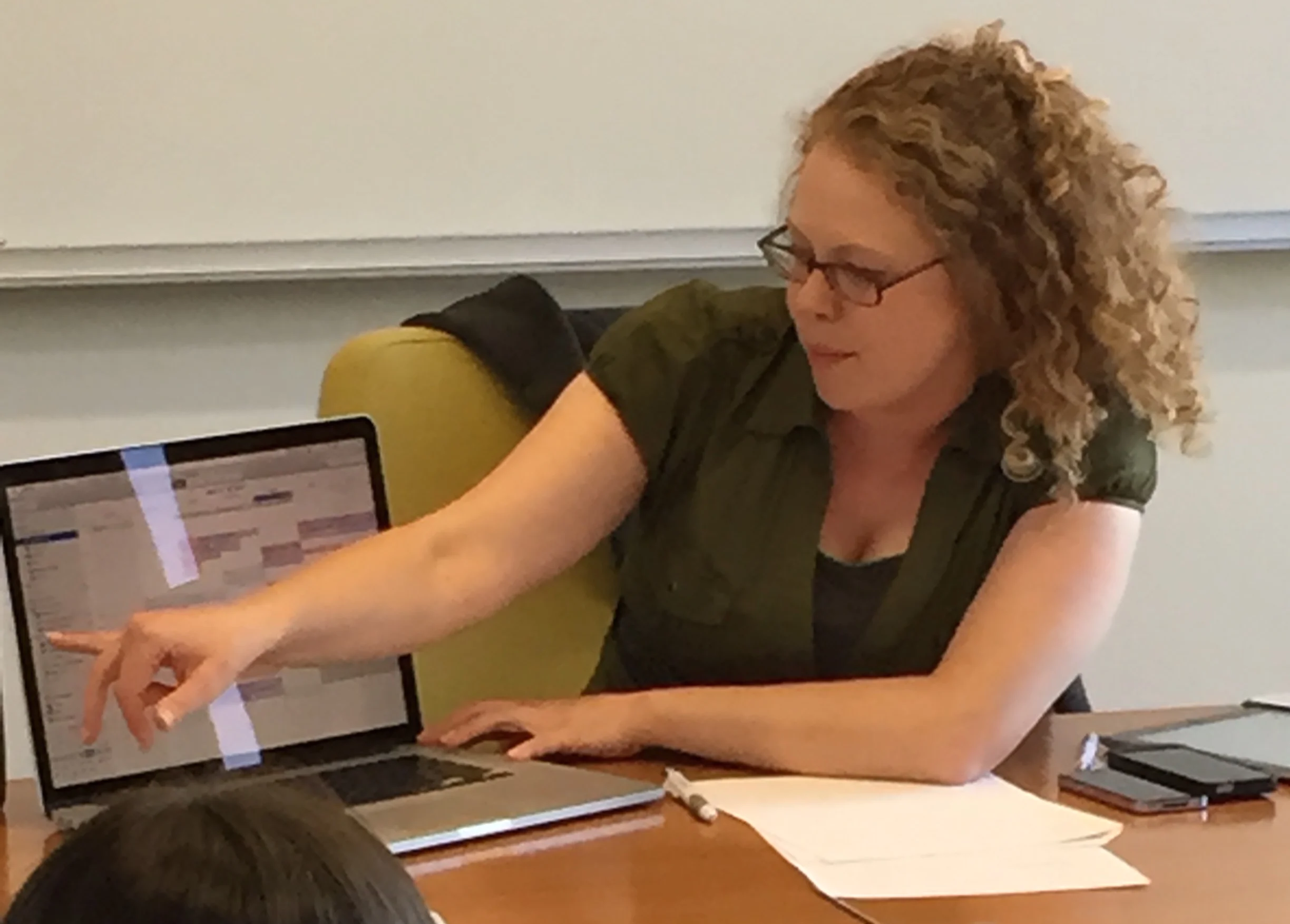 Brittany (Productivity coach) is presenting on task management and calendar management to an ADHD Coaching group. She is recommending apps to use on computers, iPhones, and iPads. She is pointing out calendars that might be useful to use.