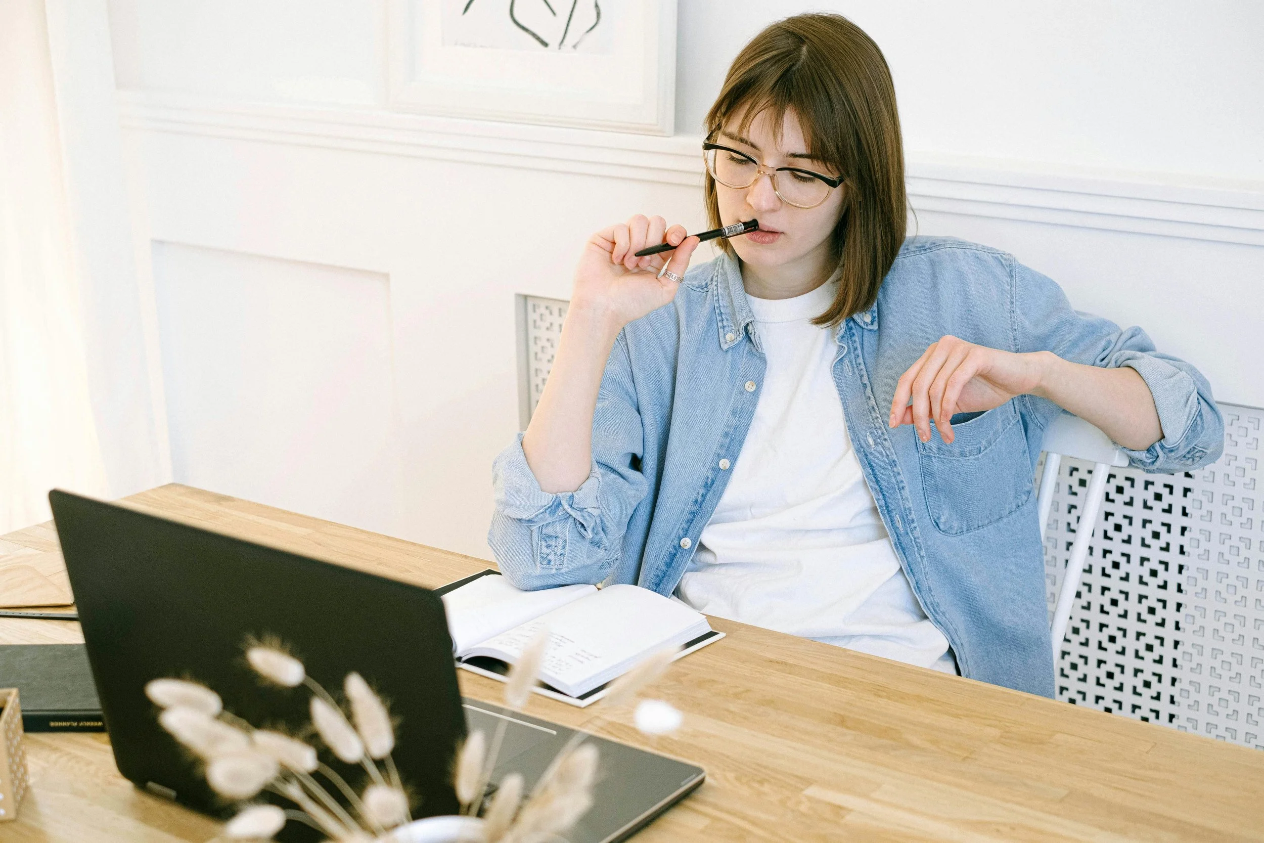 a woman sitting at her desk making descisions