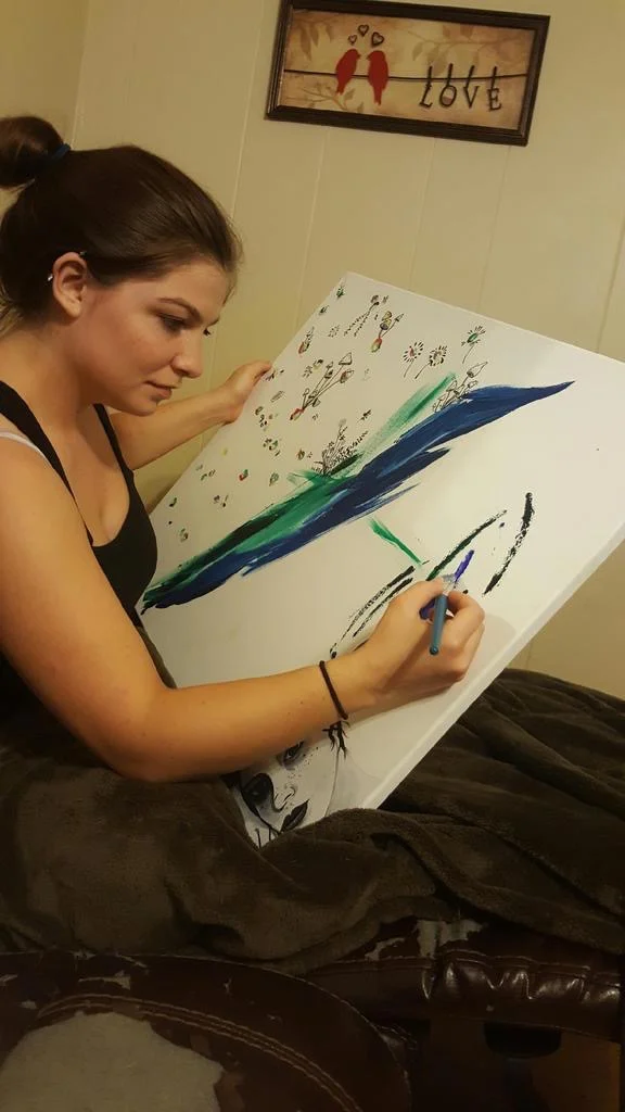 "Ok, so to be honest the reason I usually paint is to relieve stress, I have a hard time managing my stress and painting has always been a way to clear my mind and relieve the stress." "So my art work is not perfect and I usually don't plan it, I simply clear my mind, play music and paint randomness and just paint whatever comes to mind at that time. That's also why I chose to use oil paint, I love the way oil paint blends, together, it always makes a beautiful combination so oil paint is usually the medium I use on my art. I also chose blue, purple, green, gray and white because they are cool, calming colors. I chose to paint this piece in that placement because the girl in the painting stuck out to me, so my idea was her thoughts being free, like mine are when I paint. Her thoughts being calm, random and free." - Heather Bouza