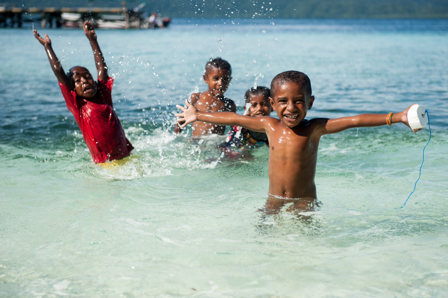 Arborek Island children having tons of fun in the water.