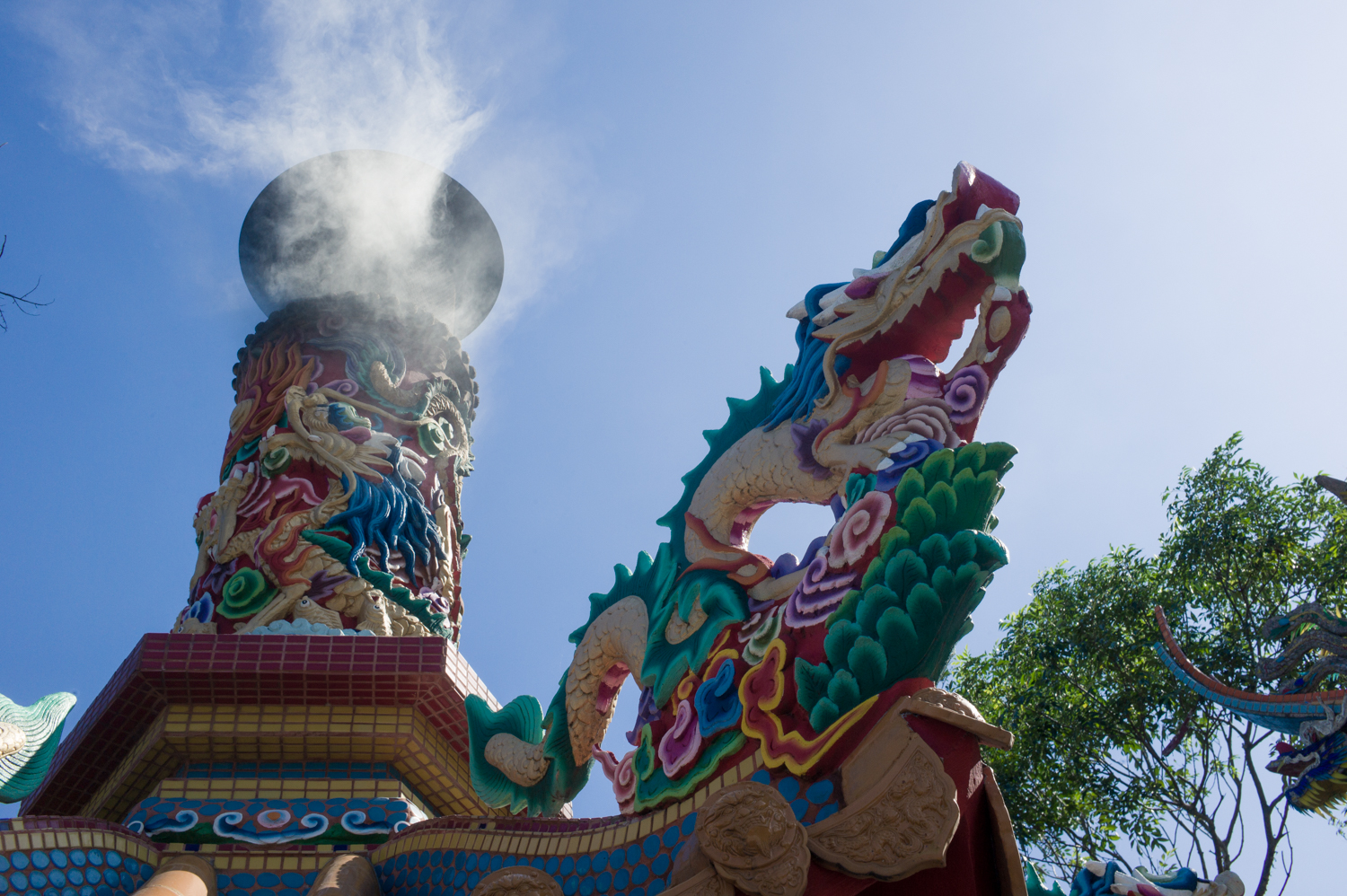 Furnance smoke from burning paper offerings in the temple.