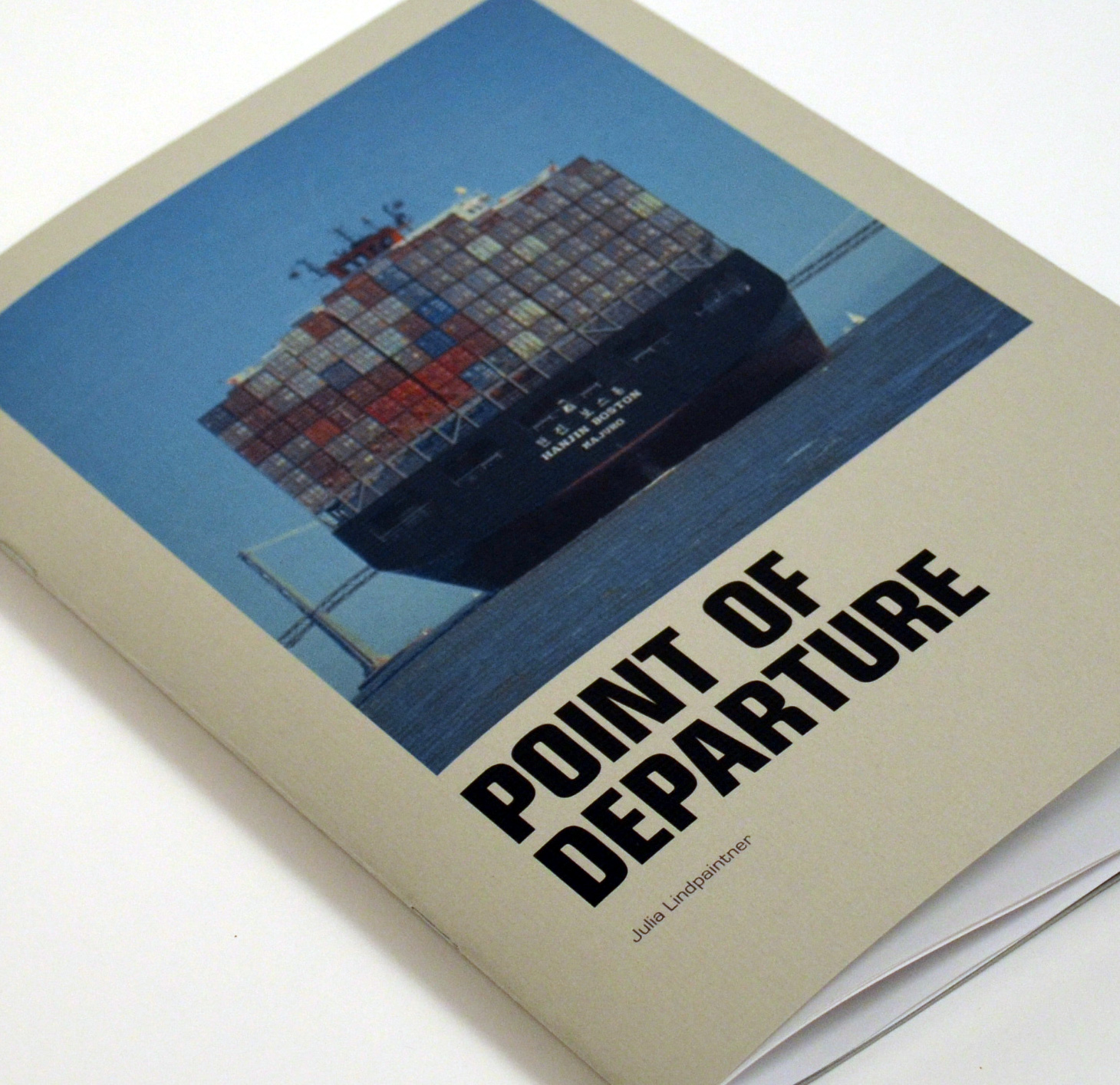 Book cover showing a container ship with the title Point of Departure