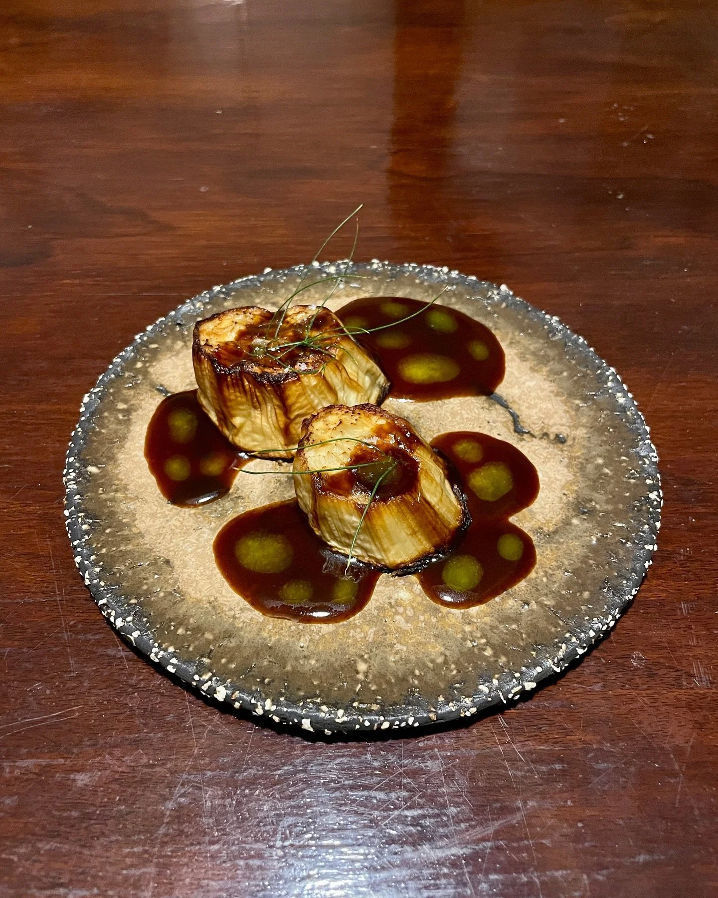 Roasted white eggplant with vegetable demiglace, leek oil, and fennel fronds. 

This dish is pure umami and completely vegan. I don&rsquo;t think a year ago something like this even though it is so simple would have ever occurred to me. To me, this i