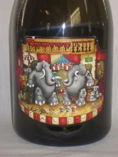 Michael David - 2012 Lodi Petite Petit ($27 1.5L) I always passed by this cartoon character label with the two elephants sipping wine. But Wine Enthusiast recently named this wine their #2 pick on the 2015 top 100 wines, giving it a 94 point rating. That caught my eye! And, as it happened, I found this 1.5 liter magnum at an amazing price. So, as Wine Enthusiast says " Don't let the cartoony label fool you, this is a fantastic wine ." This is dark red wine with big rich fruit flavors. But, as Wine Enthusiast goes on " For all its density and depth, however, this is not an overpowering monster. " A really good highly rated wine at a terrific price. You need try this one!
