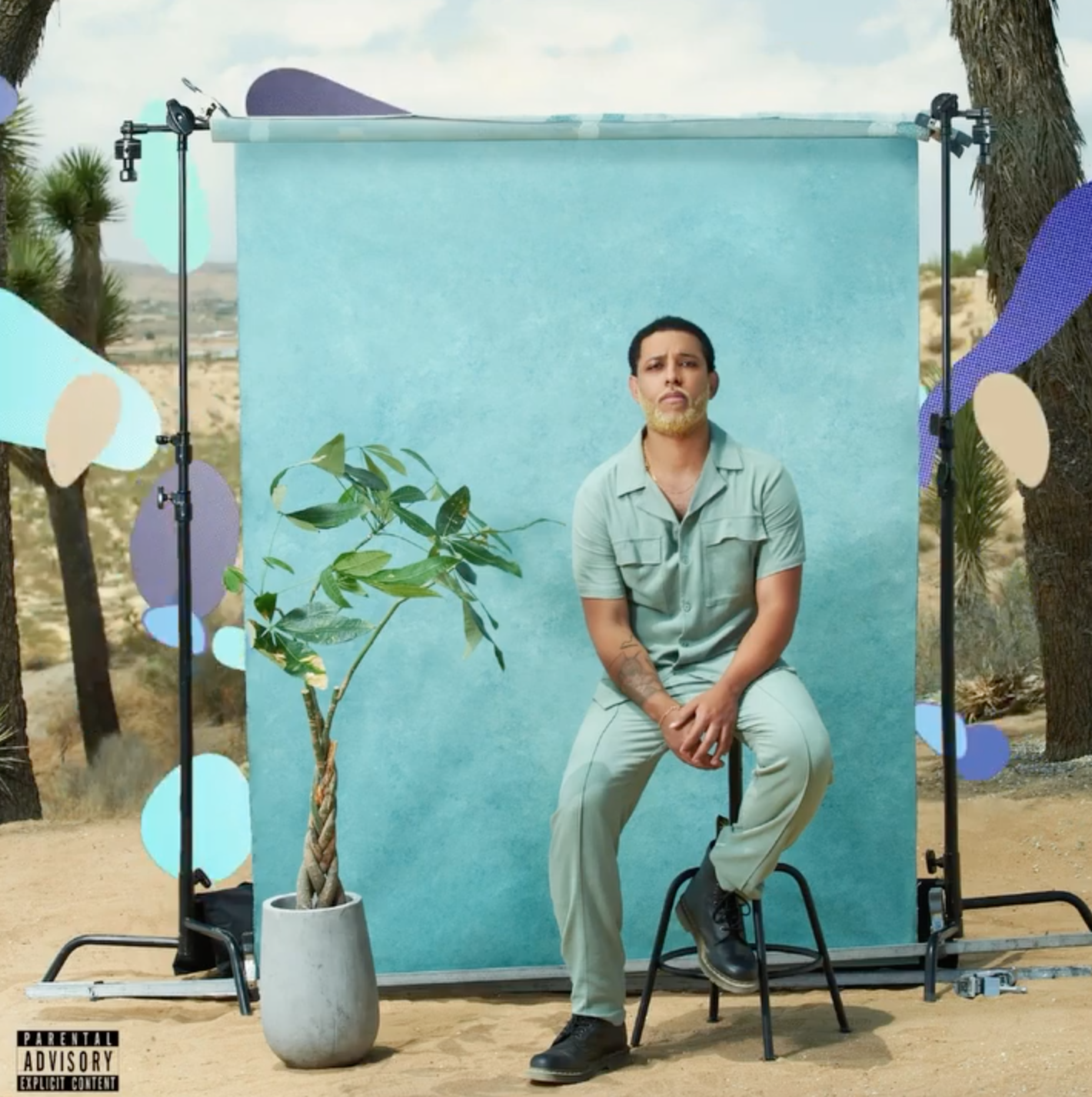  Musician, Alexander Nate, in matching blue set, poses in front of back drop for this album cover. Styled by Emily Burnette.  