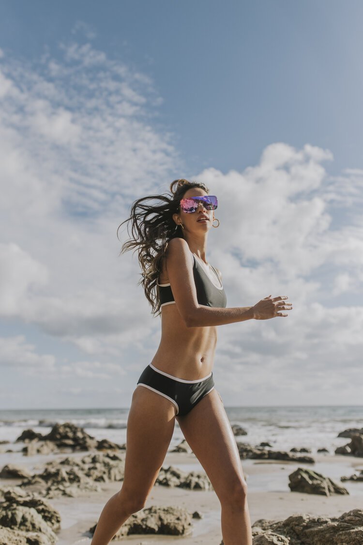  Model running in Malibu with sport sunglasses. Styled by Emily Burnette.  