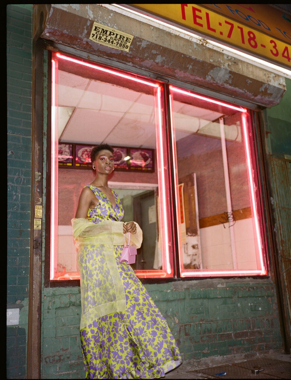  Model posing in Brooklyn, New York against Chinese takeout in high-fashion, styled by Emily Burnette.  