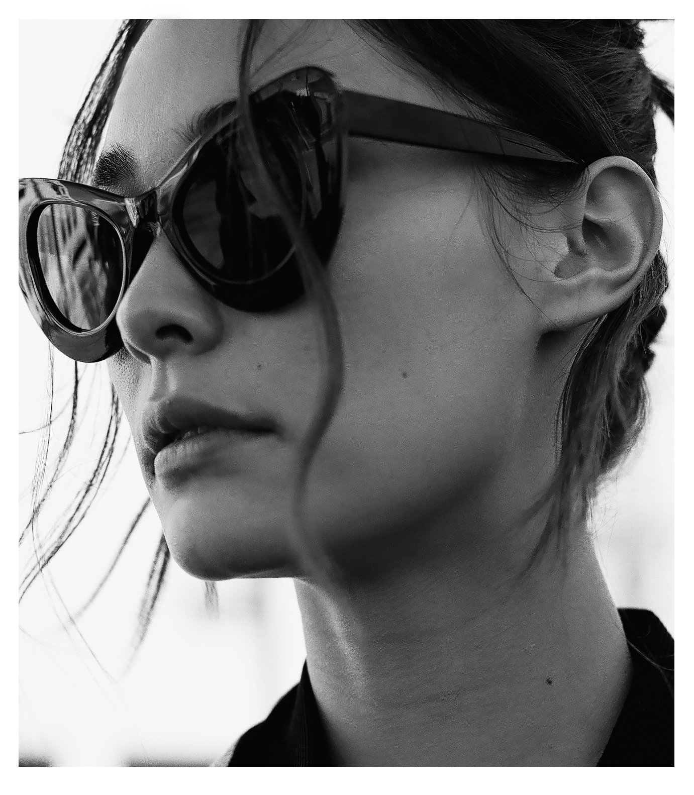  Model shot in black and white styled with over-sized cat eye sunglasses. Styled by Emily Burnette. 