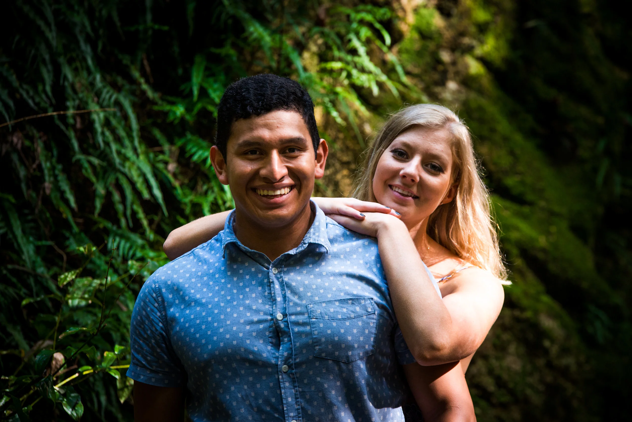 Engaged couple in rain forest