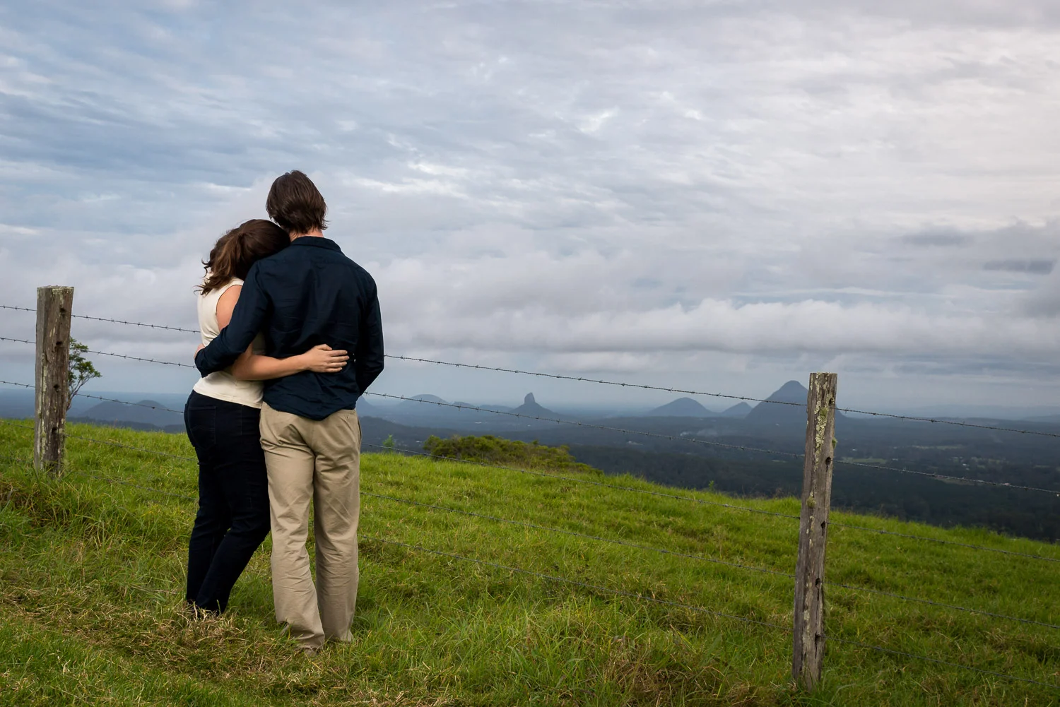 couple embracing with mountains in background