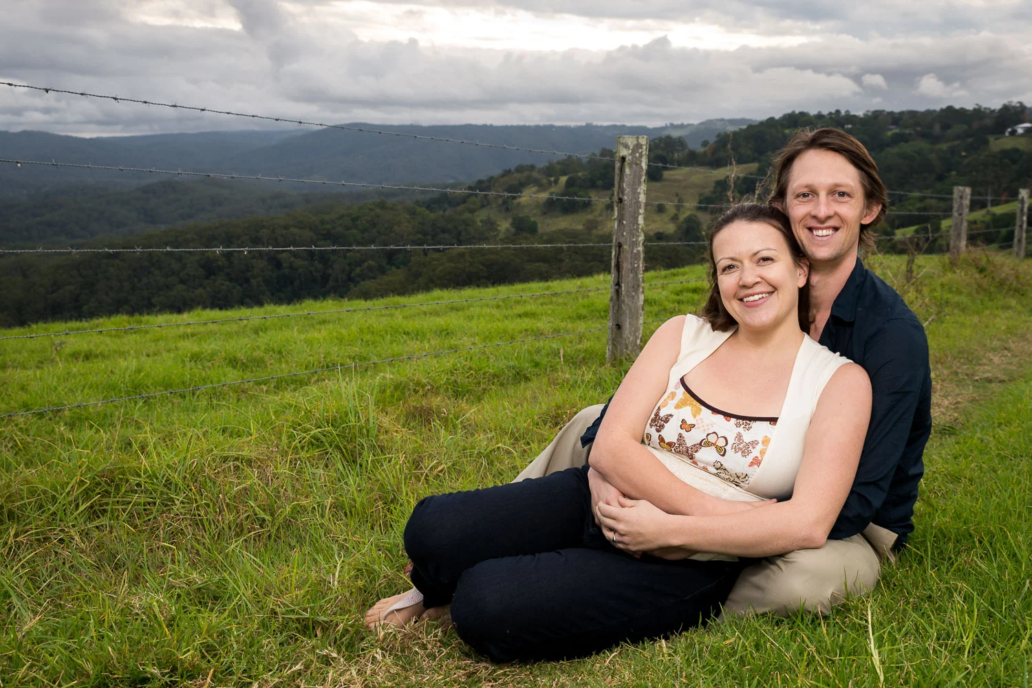 couple embracing with rolling hills in background