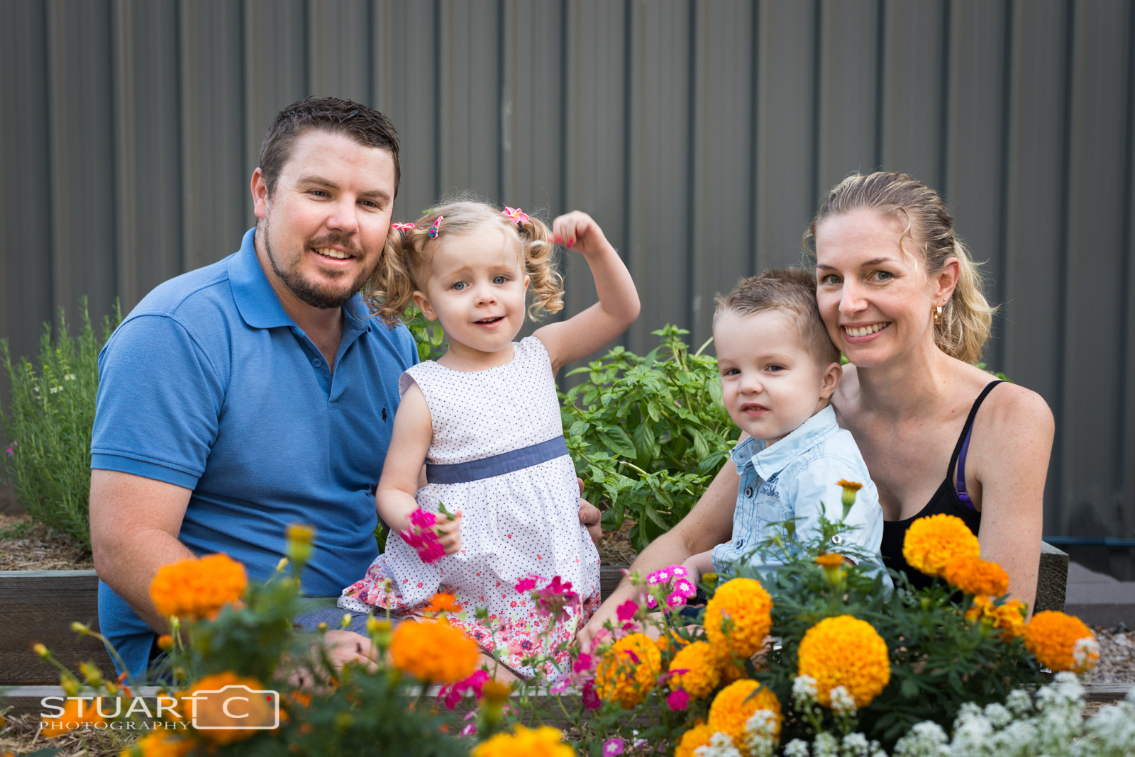 Outdoor family photo in their backyard vegie patch