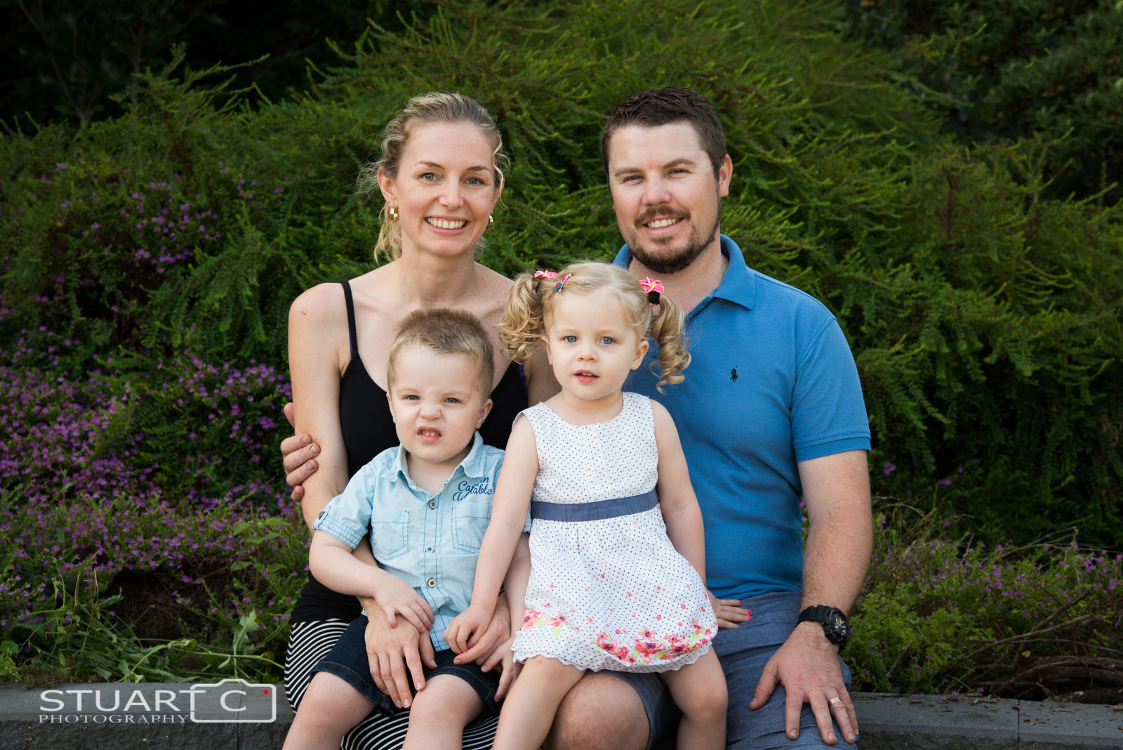 Posed family photo outdoor in lush gardens at home