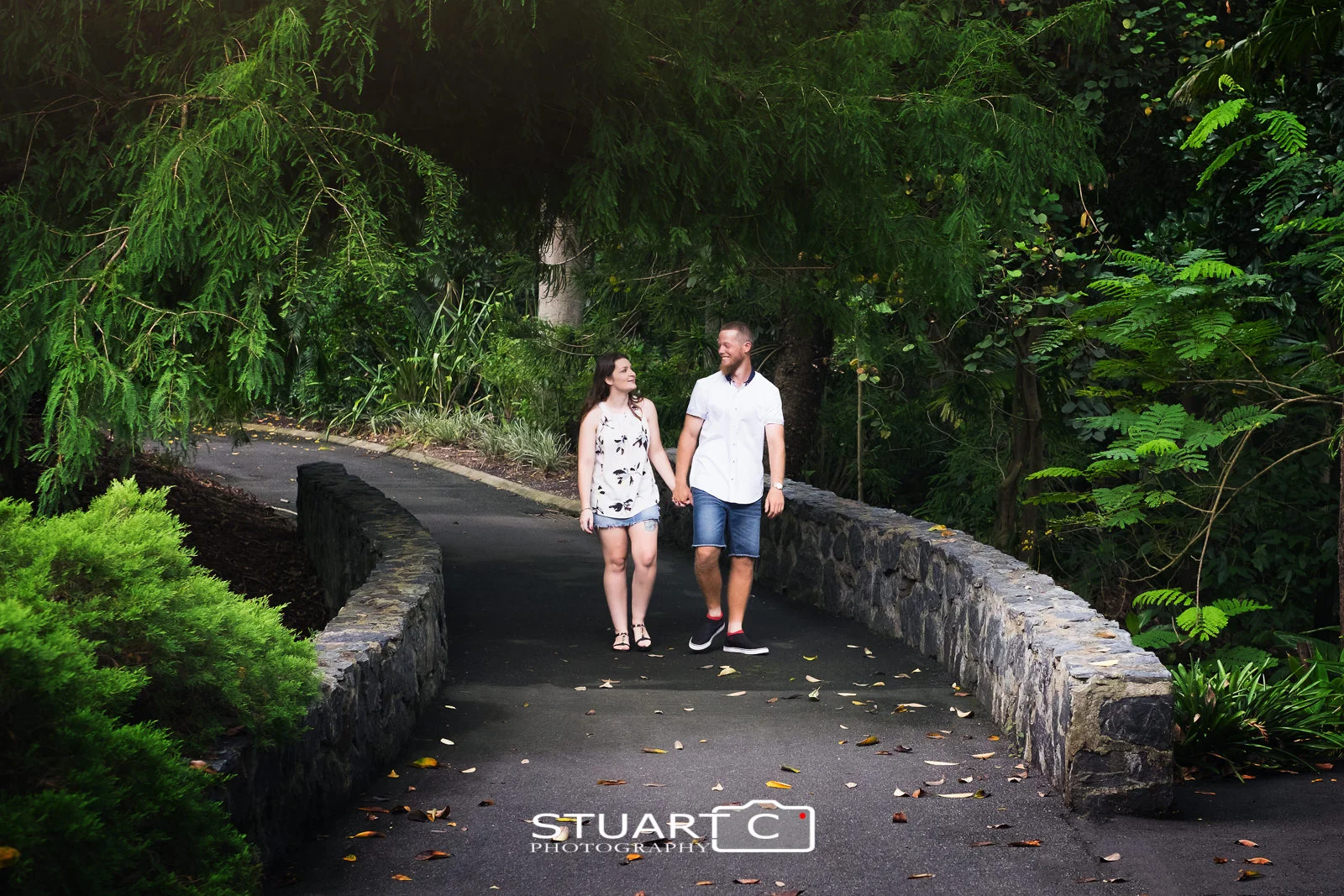 Newly engaged couple, Casey and Gary, enjoying a walk over the foot bridge at Mt Cootha Botanical Gardens during their photo shoot.