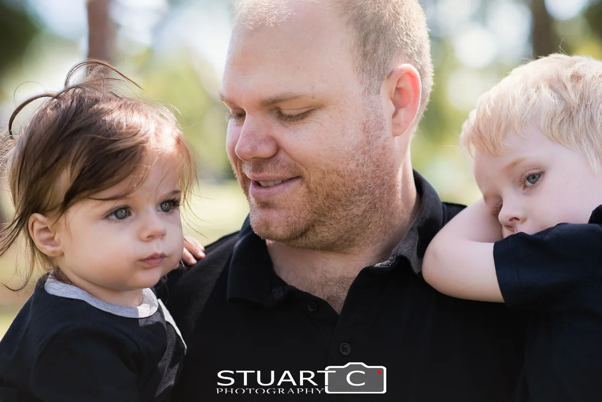 Outdoor natural light Portrait of father and his two sons in a Beachmere park