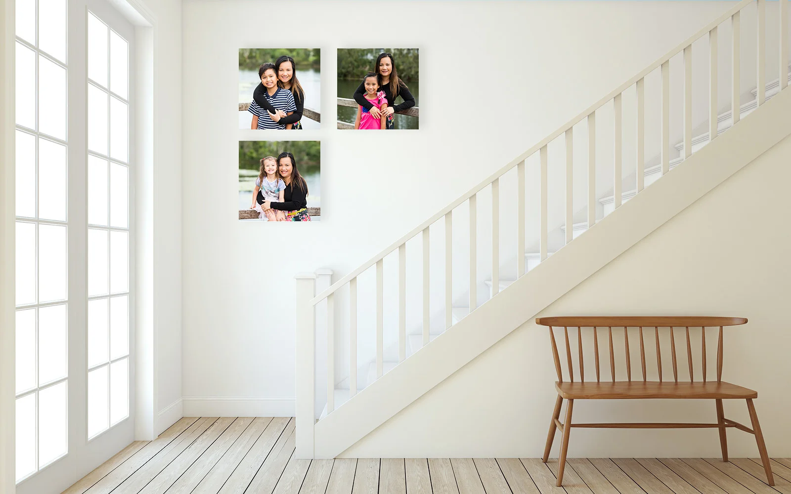 Family portraits shown on 3 canvas prints in hallway going up stairs by caboolture outdoor family photographer