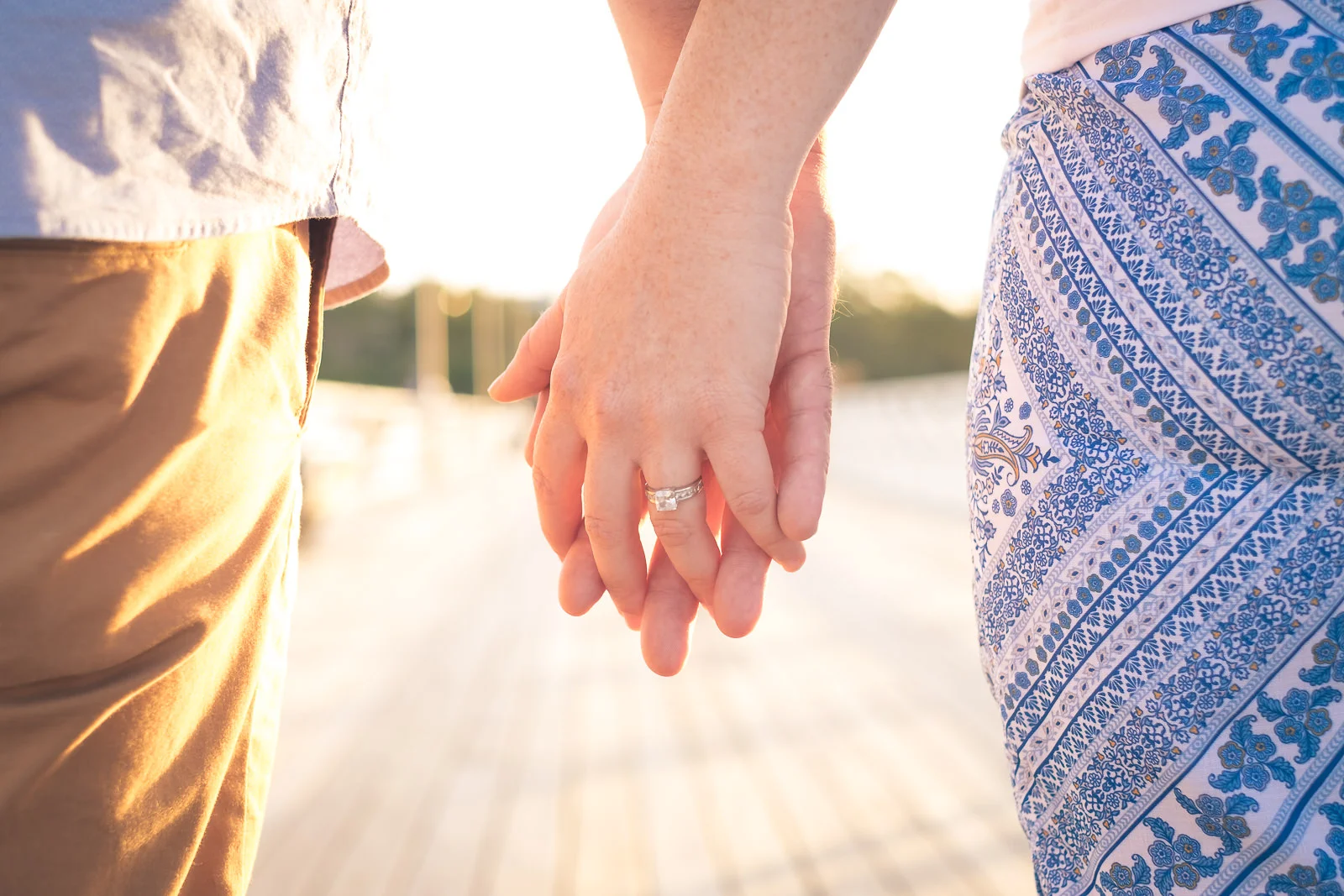 Close up of engaged couple holding hands on shorncliffe pier