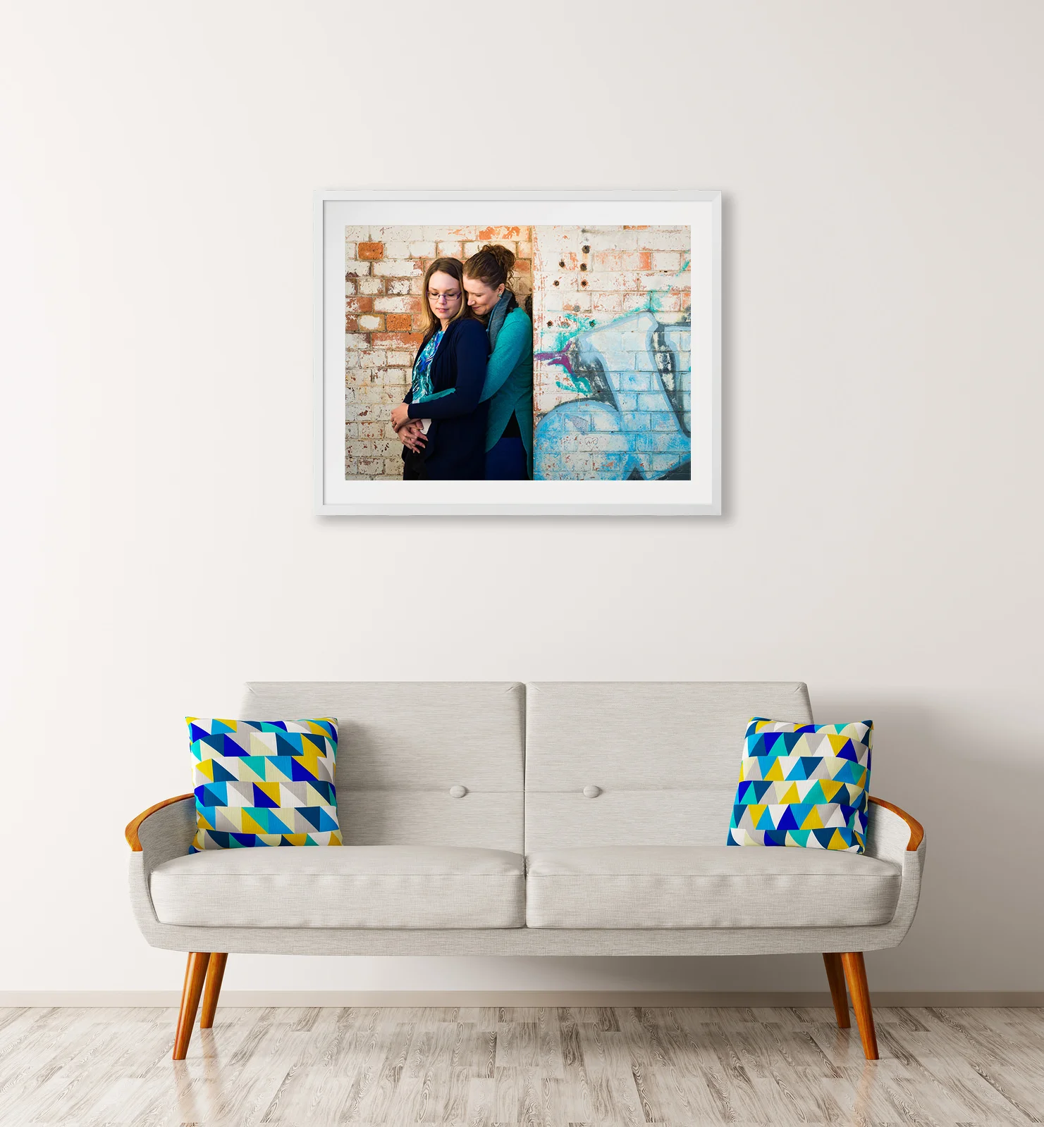 Framed engagement portrait above couch in lounge room