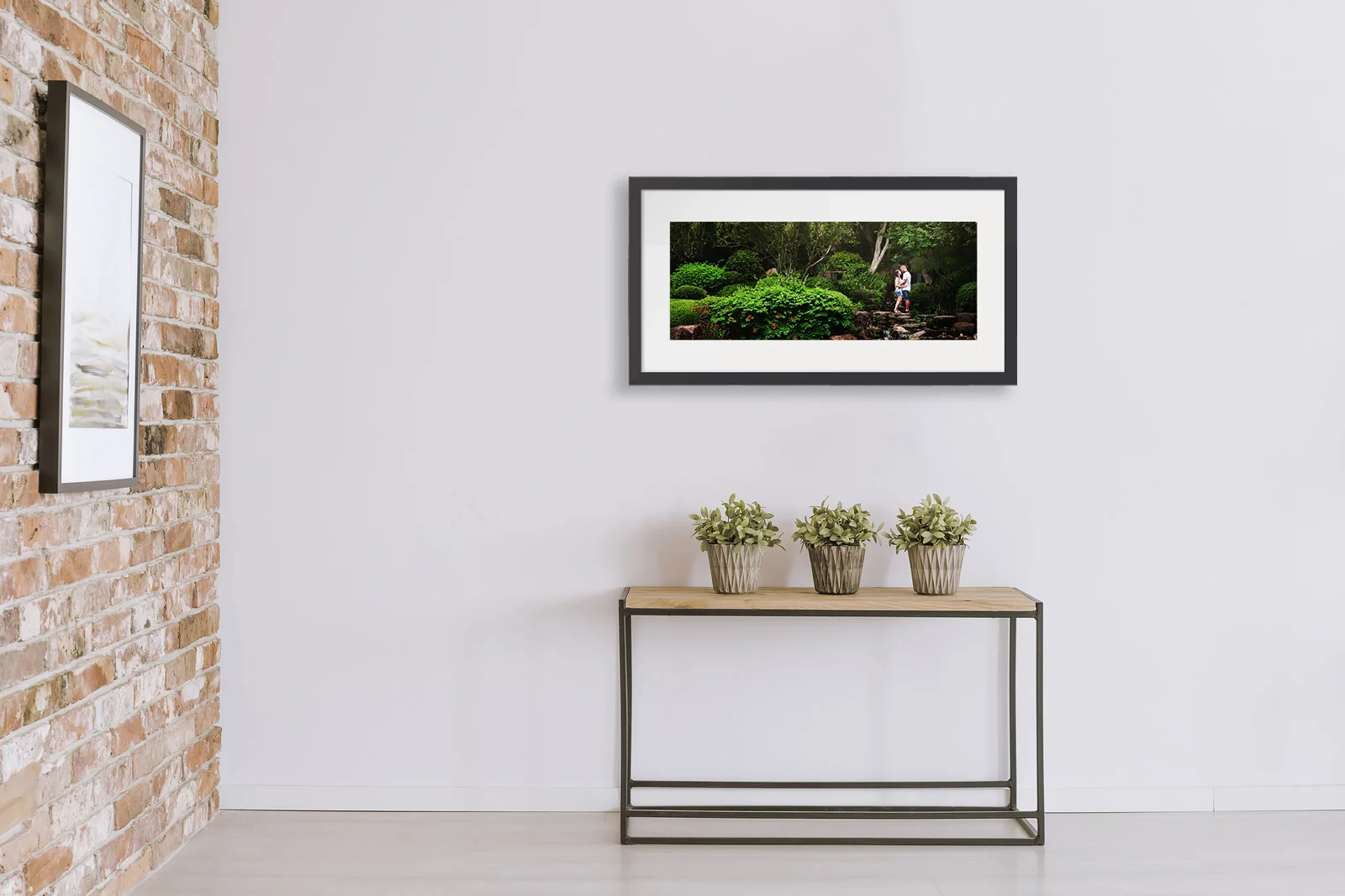 Framed print of engaged couple in garden shown above a hall table