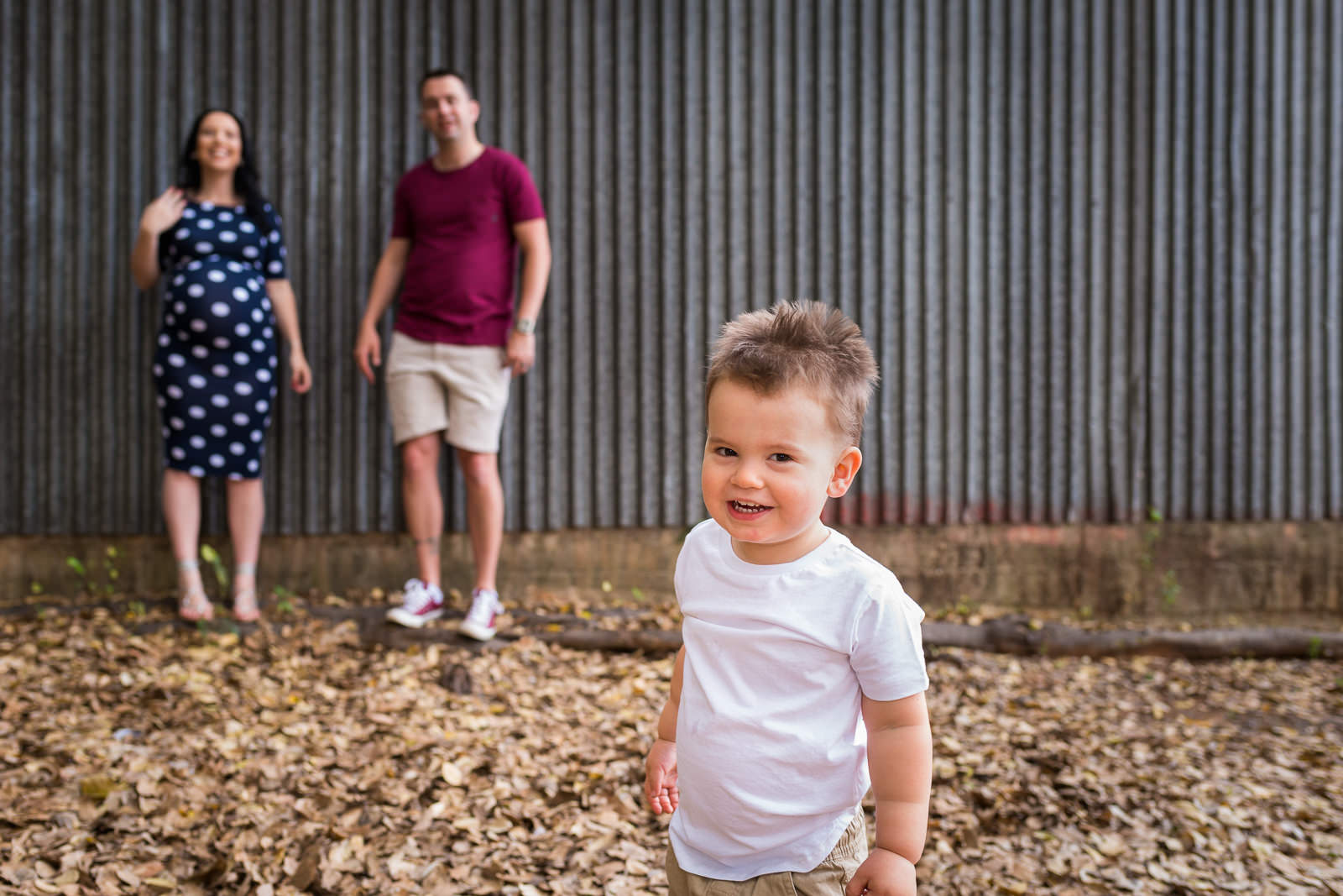 Urban family portrait with corrugated iron wall in caboolture