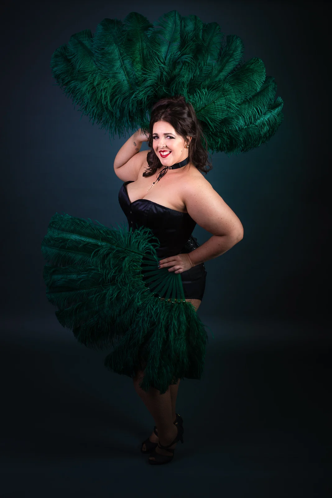 Cora Confetti burlesque performer with Bombshell Burlesque Academy, full length pose with green feather fans. Caboolture portrait photographer