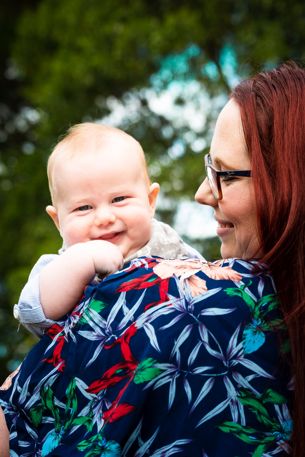 Baby boy looking over mums shoulder during family photos at beerwah