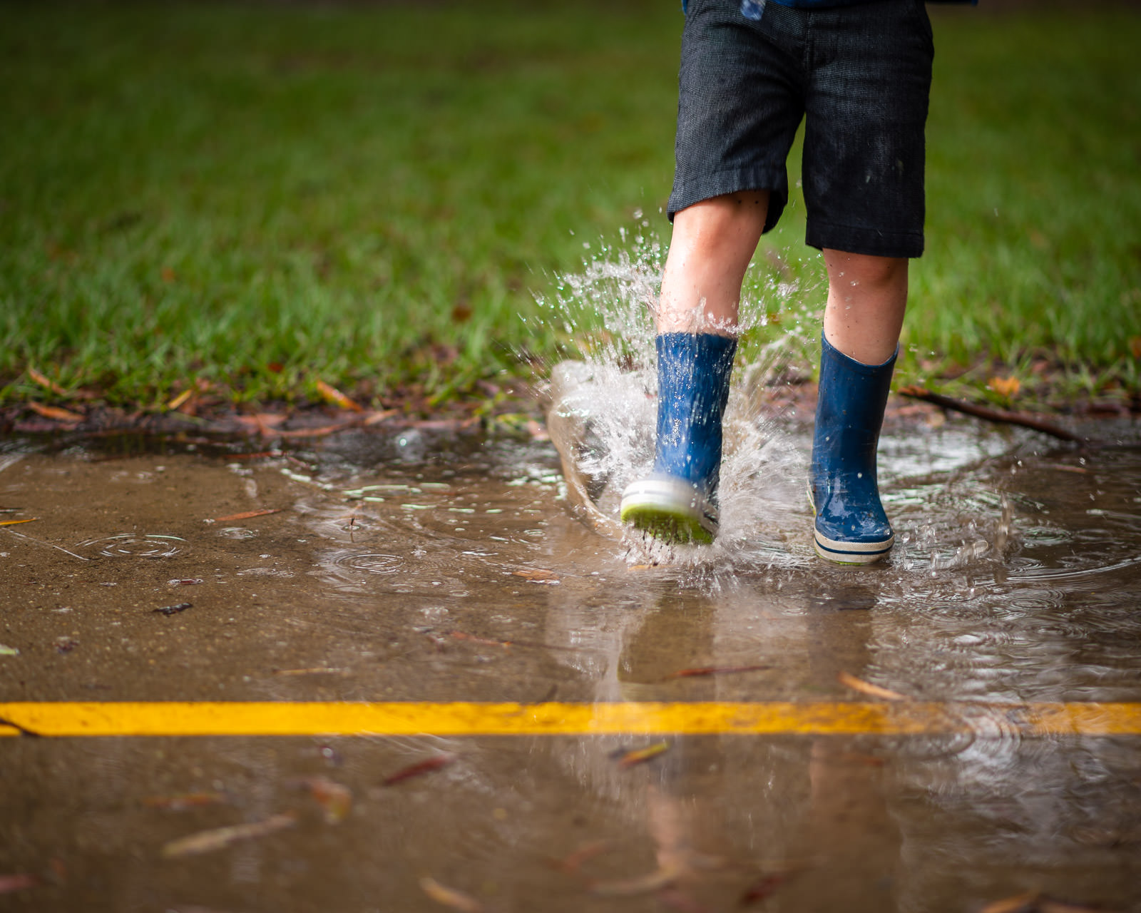 Close up of boys gumboots splashing in water | Caboolture outdoor family portraits