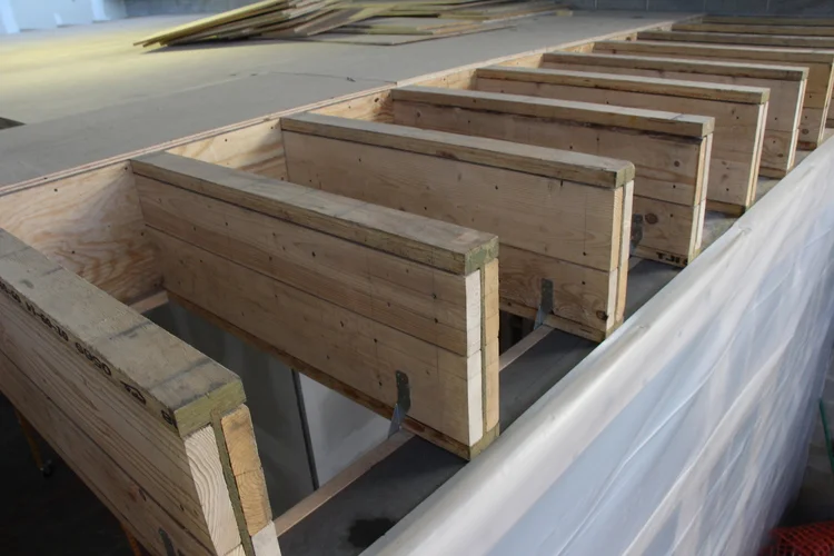 To maintain a glazed ceiling perimeter, there is no rim joist on the TJIs. Instead these 560 16" deep TJIs were scabbed on both ends and 2x4 shear diaphragms tie the TJI's together.