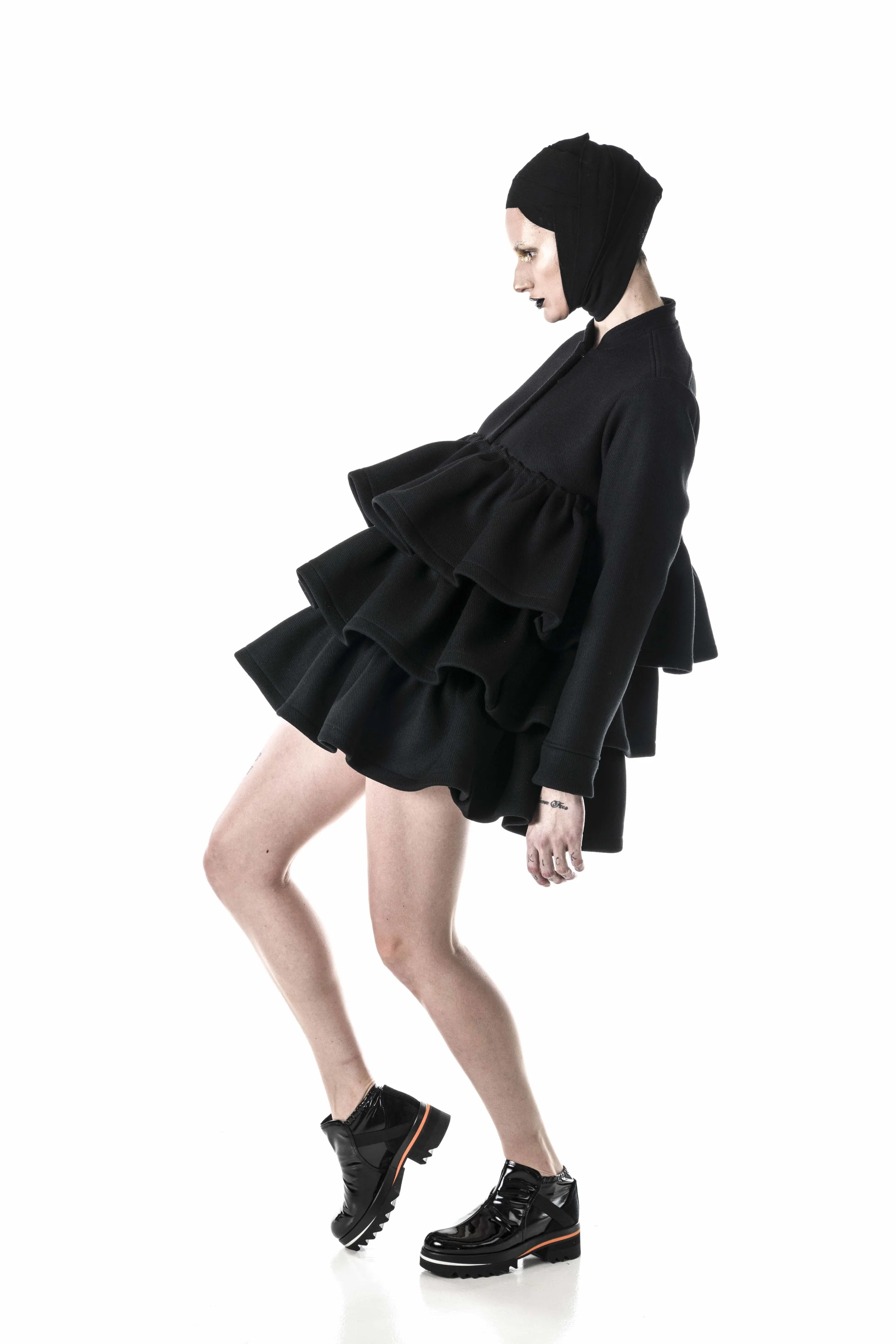 Dress made in 800 gr wool. Cuff, collar and shoulder details are from classical uniform jackets. In contrast with three layers of folded skirts, makes it more feminine and not so strict. 
