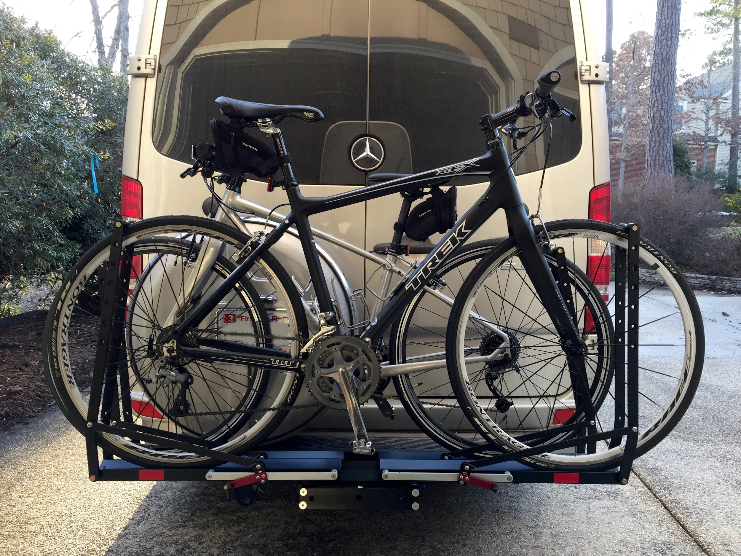 This shot angle is deceptive -- the bikes do not actually extend beyond the width of the van.