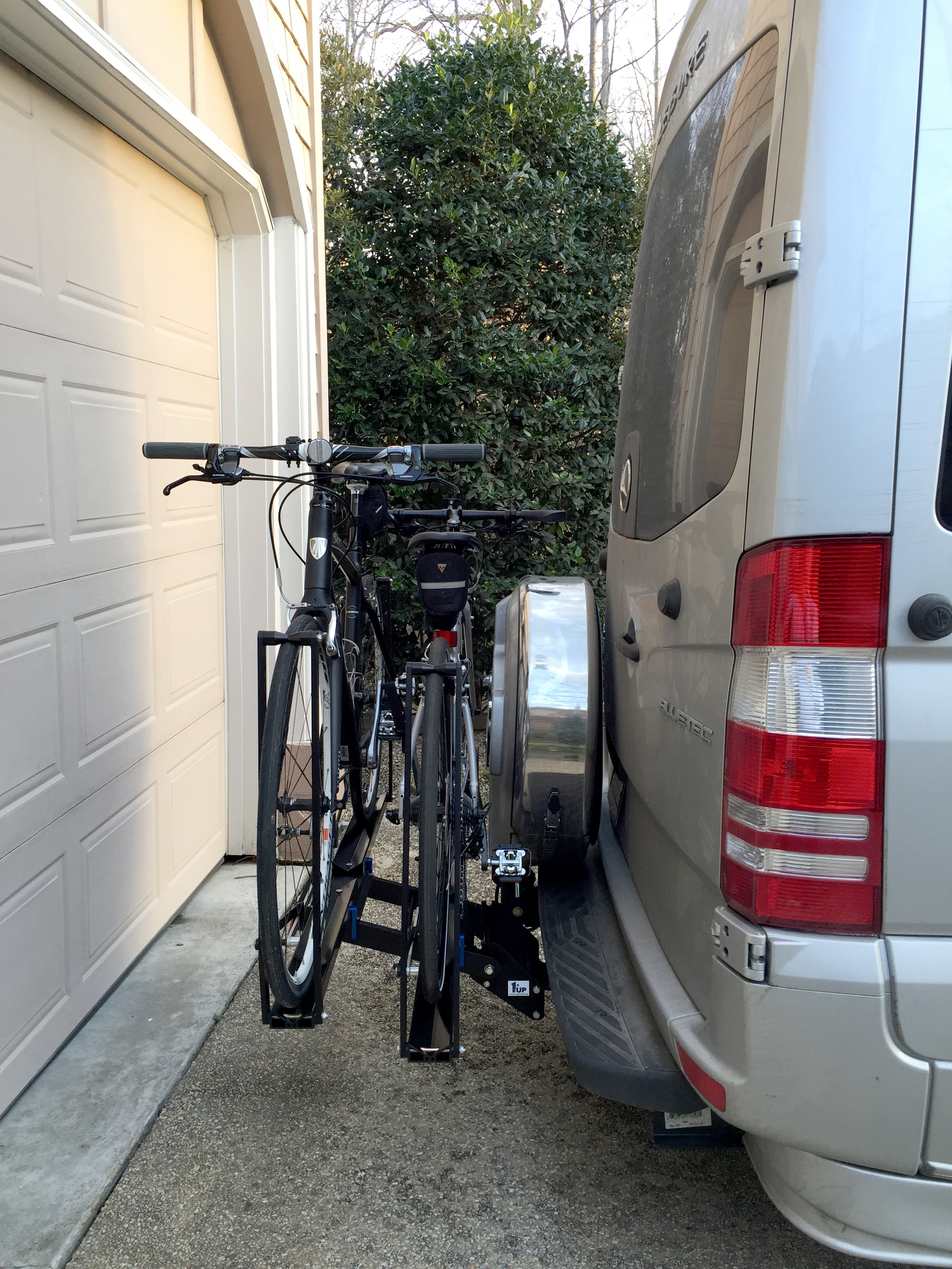 Bikes clear the spare tire carrier on the Free Spirit. Without the bikes mounted, you can fold up the rack only if you add a hitch extender .