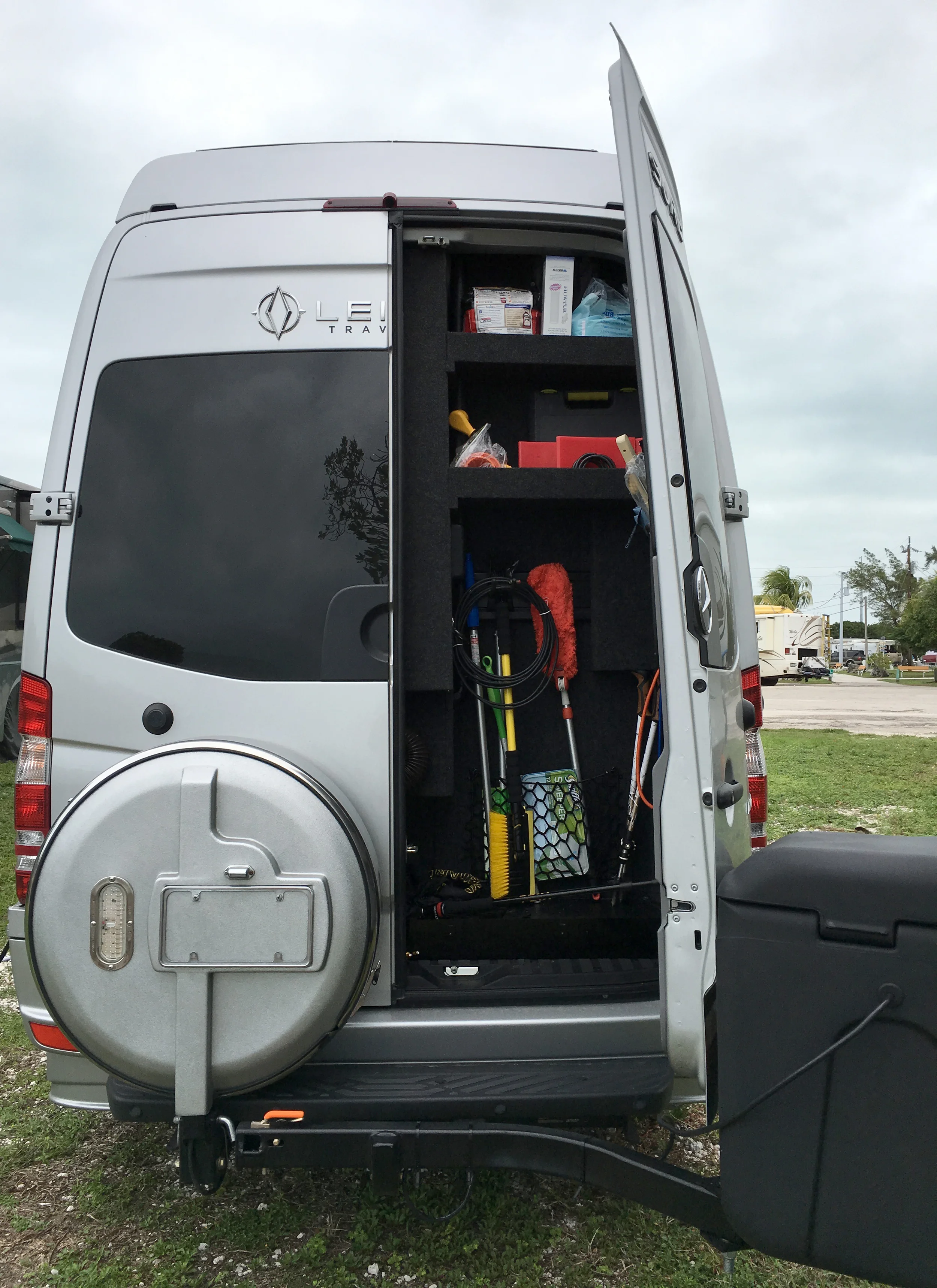 The right rear door of our Sprinter van is still able to open almost 90 degrees with the cargo box in the swing-away position.