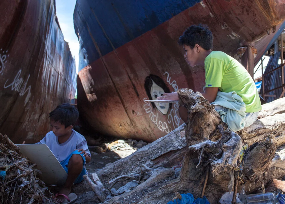   Children in the coastal community of Anibong sketched on note pads donated by a local organization. In one afternoon program, they recalled the trauma of surviving the typhoon's&nbsp;record storm surge and winds, which tossed cargo ships onto land 