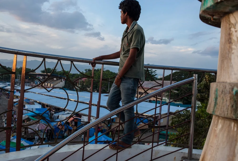   Aljim Asbi, 14, and his friends at the Joaquin Enriquez Sports Complex climb a tower to&nbsp;escape the heat and congestion below. More than seven months since an armed conflict displaced 100,000 people in Zamboanga City, 64,600 residents remained 