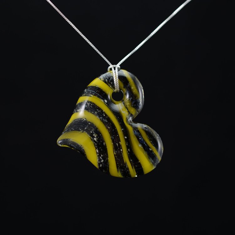 Black and yellow striped heart-shaped pendant necklace on a silver chain