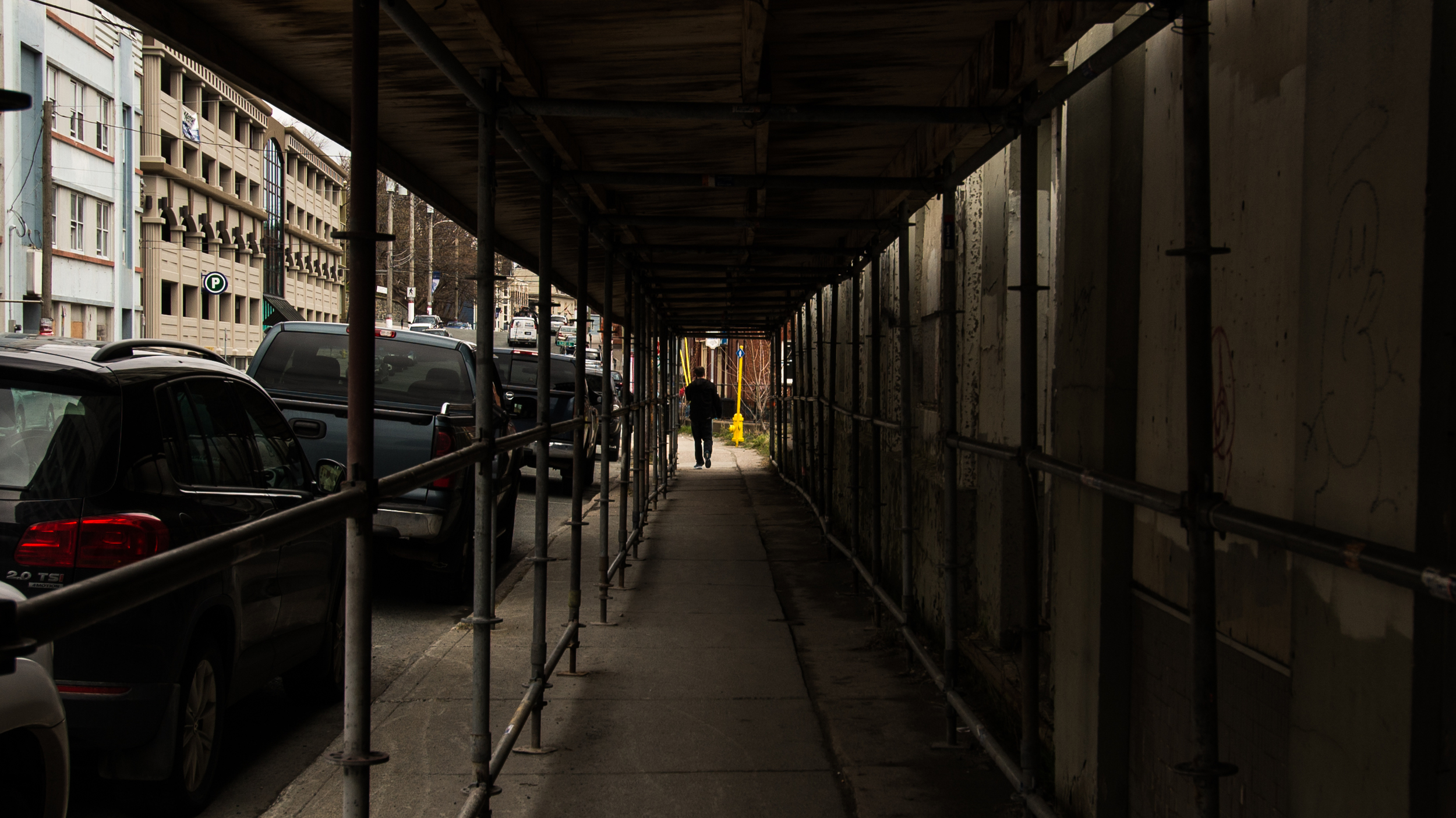 Young feller ahead of me coming out from under scaffolding on Duckworth.
