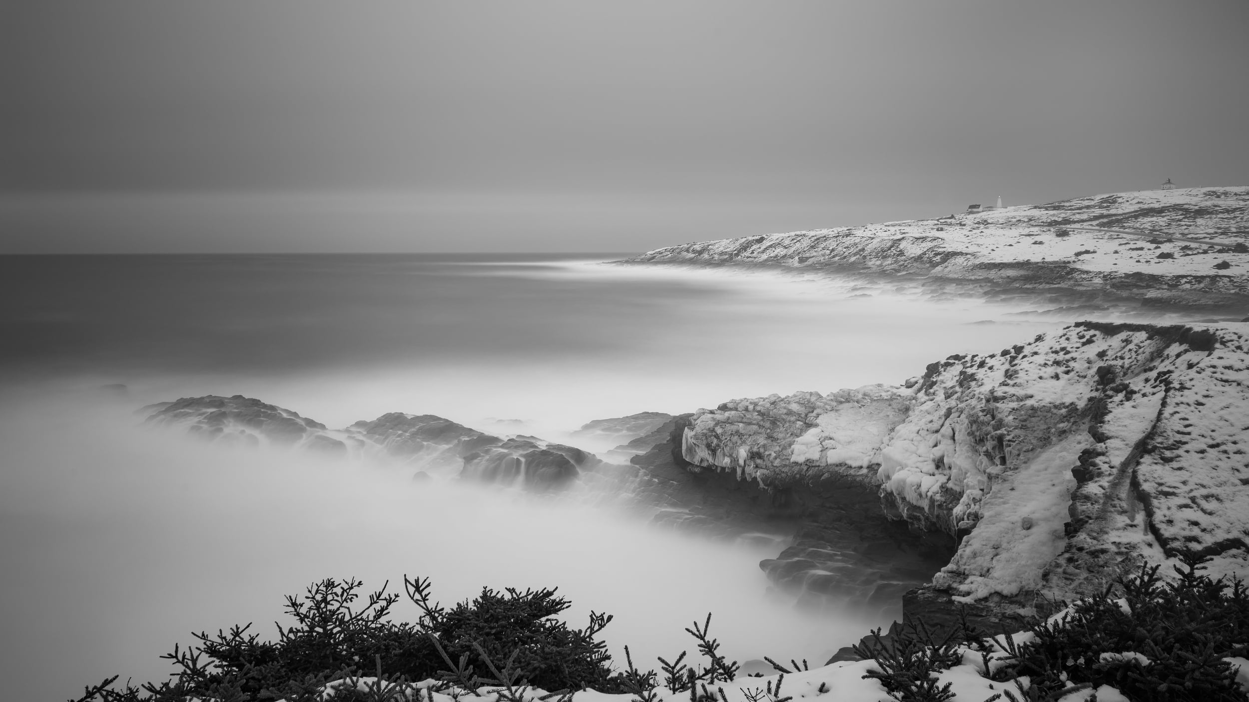 This is a three-minute exposure calming the otherwise violent waves. Time fixes everything.