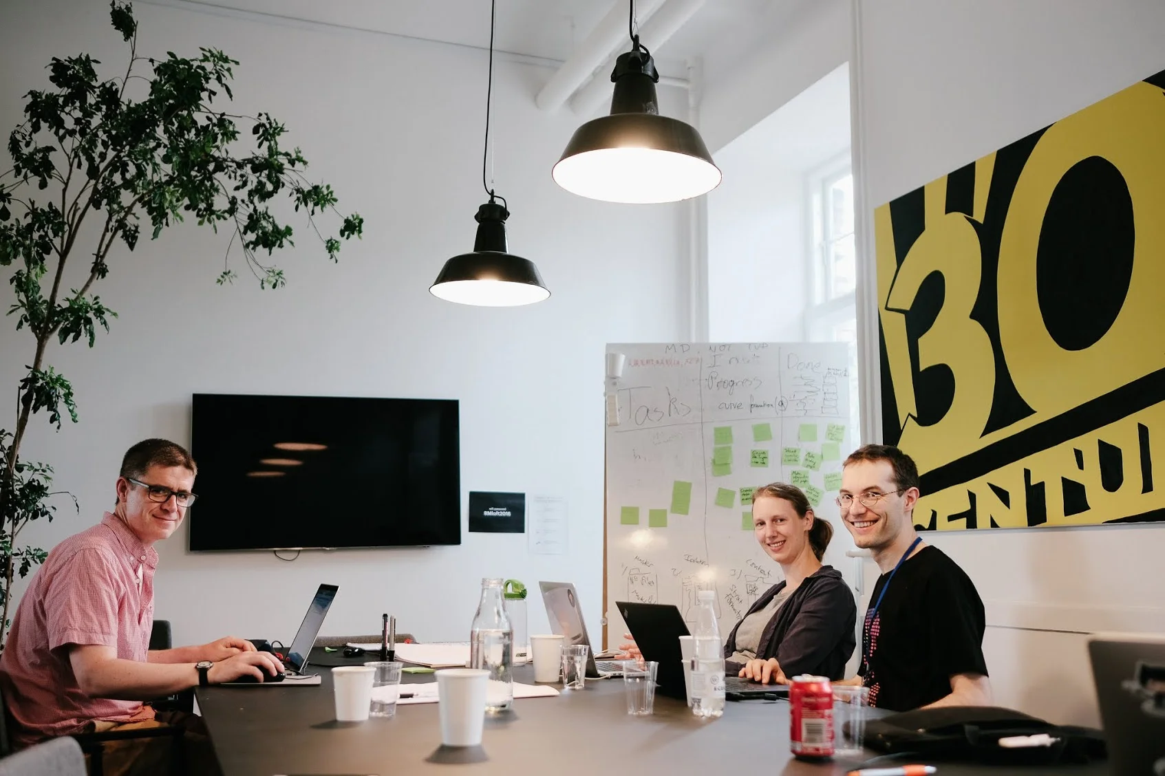 Sean, Laura, and Christian. Jo and Duncan were out doing research. Note the kanban board in the background — agile all the way!