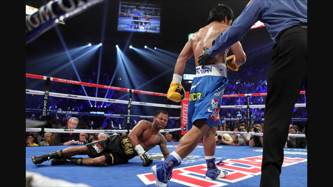 Pacquiao walking away after he drops Mosley with a straight left. Photo: Tom Casino/Showtime