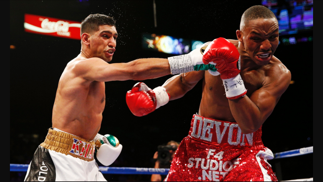 Khan lands a right hand on Devon Alexander. Photo: Jason Cairnduff/Action Images