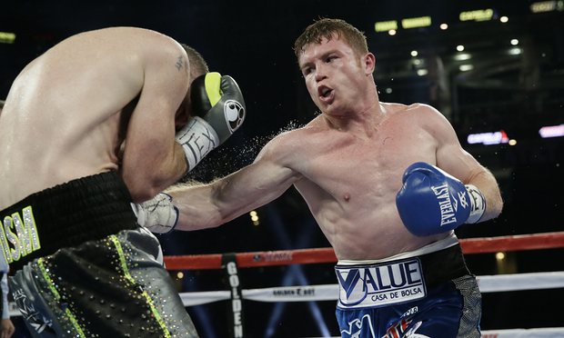 Canelo Alvarez lands a body shot on Liam Smith. Photo: LM Otero/AP