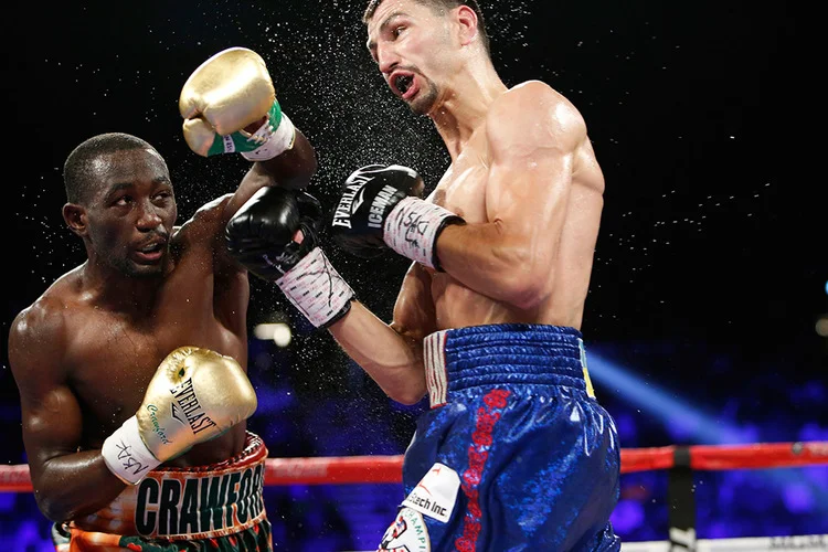 Terence Crawford lands a left hand on Viktor Postol in their 140-pound unification fight. Photo: Will Hart/HBO