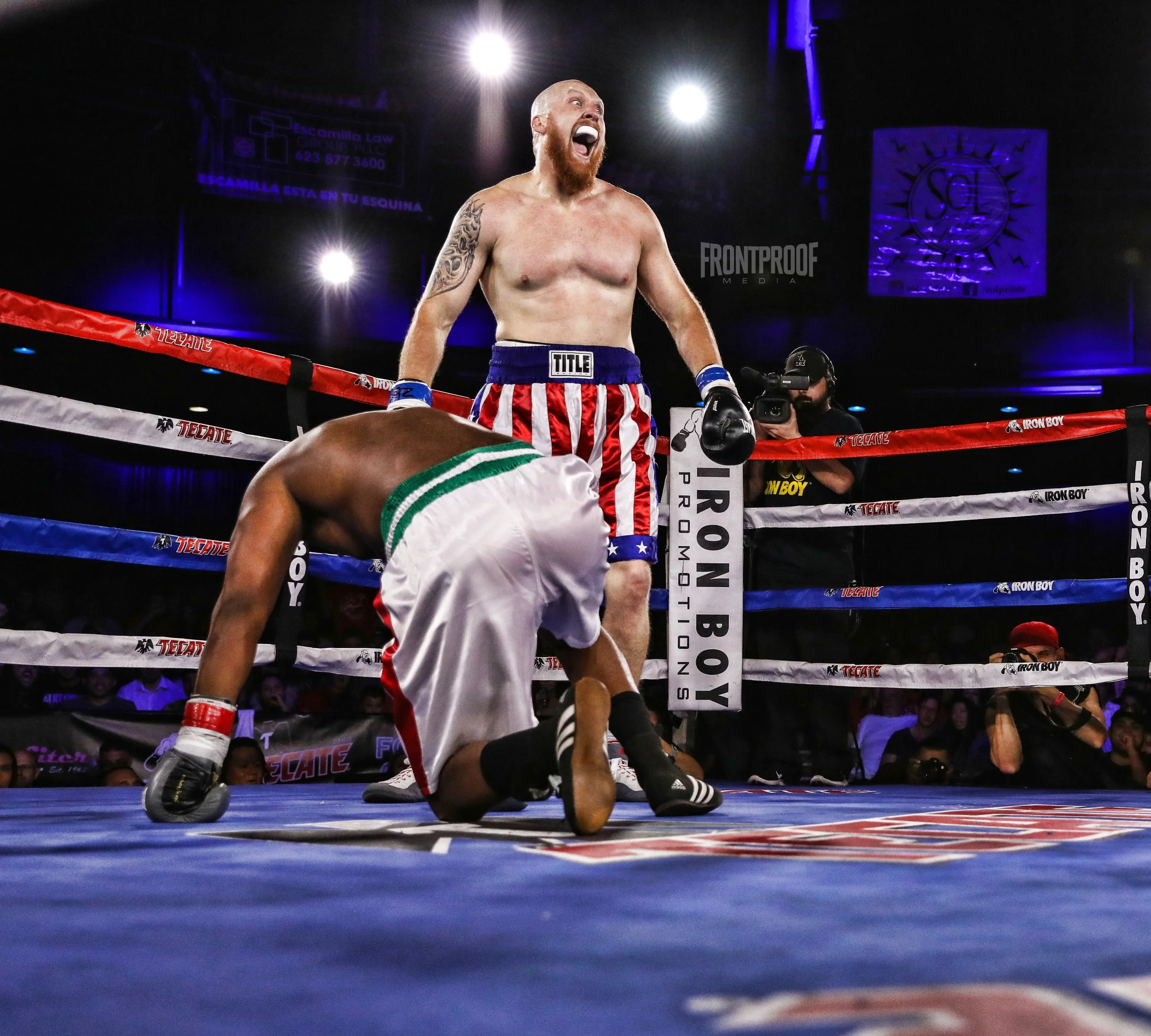 Adam Stewart (red, white & blue shorts) stands over his opponent, Michael Smith, after a first round knockdown that gave him the victory. Photo: Kelly Owen/Frontproof Media. 