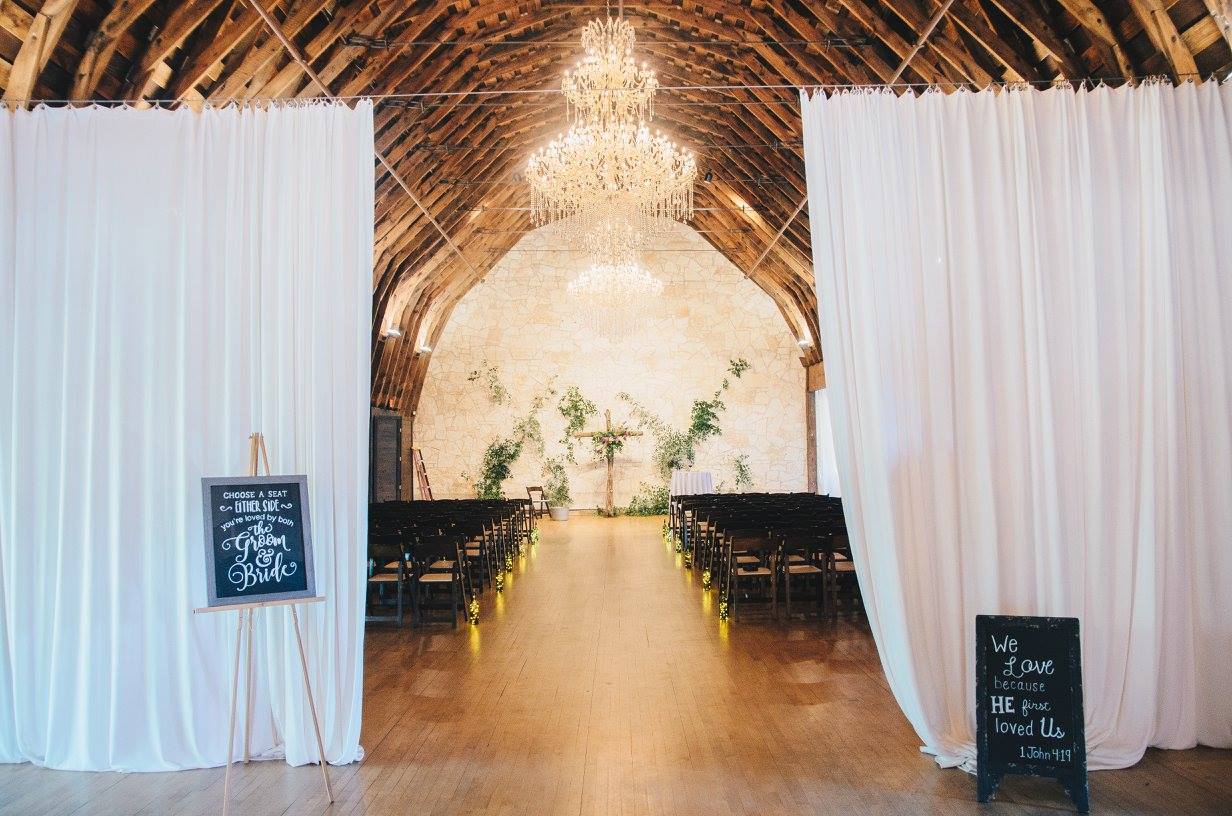 Ceremony entrance with a backdrop of locally-sourced smilax and limestone. This large, open space served the ceremony, reception, and dance. Thank you to my dear friend and wedding photographer, Elizabeth Thacker , for sourcing the smilax for me. Photo credit: Kat/Eye Studios