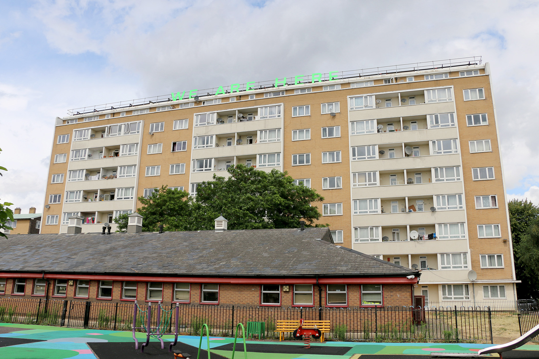 Jessie Brennan, We Are Here (2018), text installation, Pelican Estate [view from play area].jpg