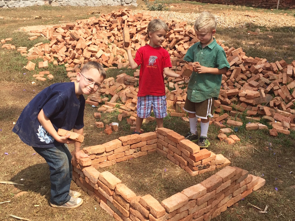 The boys make plans to begin construction on our house. :) Not really! Just playing with some bricks with their new friend, Ben. 