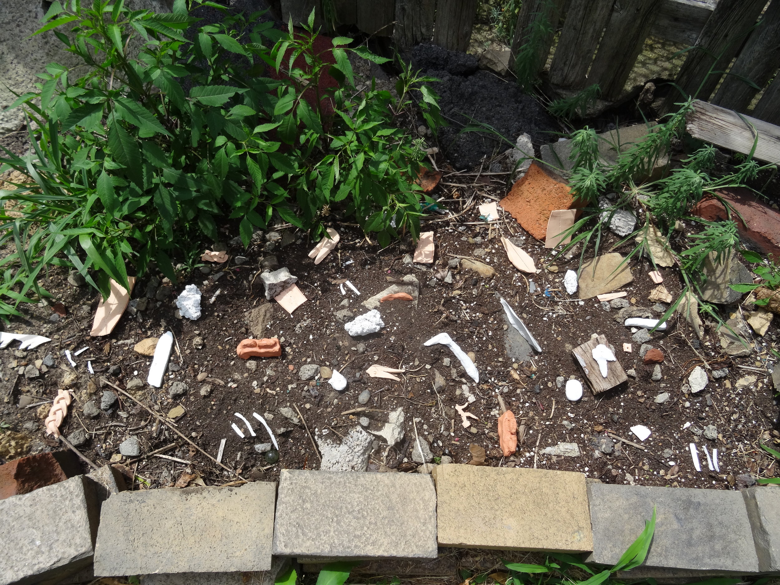  2. unswept floor after a feast, in movable parts  Fired ceramic, latex paint  dimensions variable Location: raised bed at the foot of the staircase             