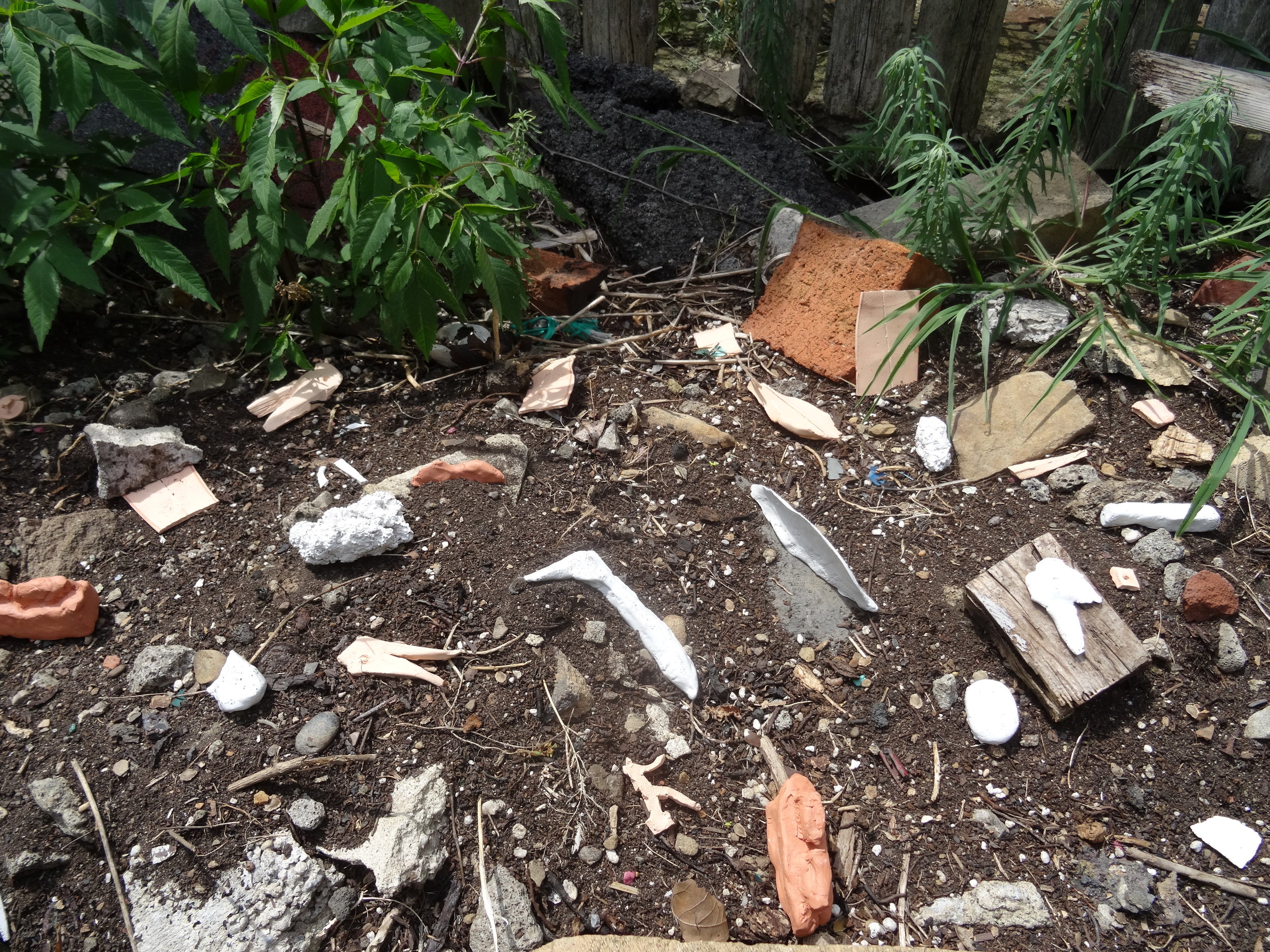  2. unswept floor after a feast, in movable parts (detail)  Fired ceramic, latex paint  dimensions variable Location: raised bed at the foot of the staircase 