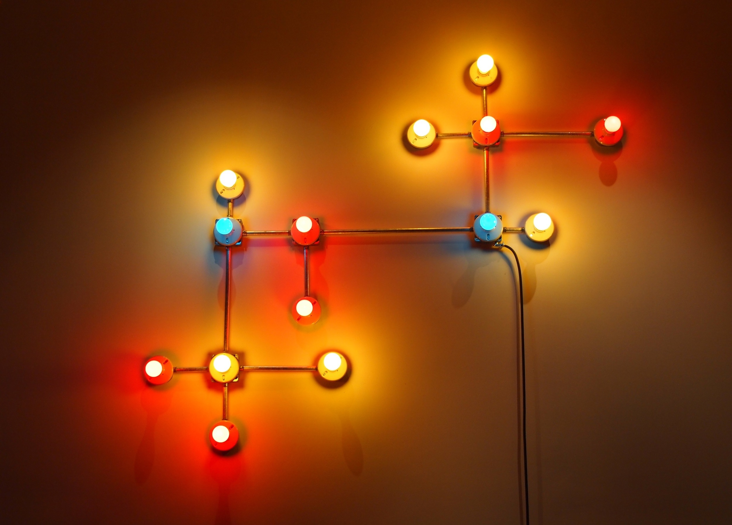   Conduits in Red, Yellow and Blue (Figure 17)  , 2013.&nbsp;  Galvanized steel, copper wire, porcelain fixtures and ceramic coated light bulbs.  