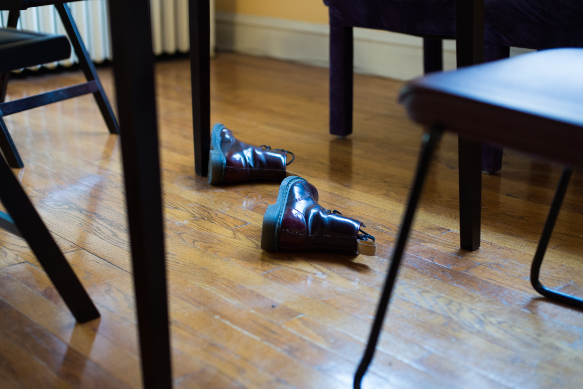 Haggerty's vegan leather Doc Marten boots lie under her table in her apartment. Although she says she's unsure exactly how vegan leather is made, she tries to avoid using animal products when she can.